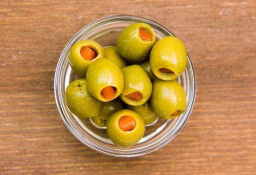 Stuffed olives in bowl on wooden top views