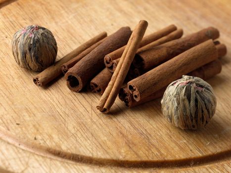 cinnamon sticks and tea flower on the wooden board
