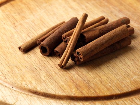 aromatic cinnamon sticks on wooden board