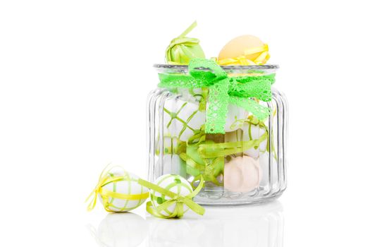 glass jar full with Easter eggs, on white background