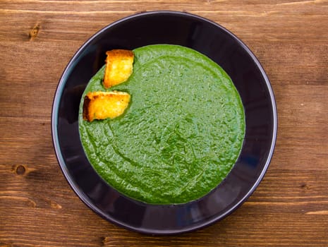 Creamed spinach with toasted wooden table top view