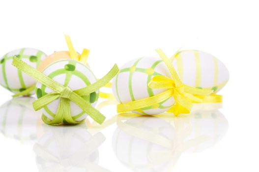 close up of colorful easter eggs, on white background