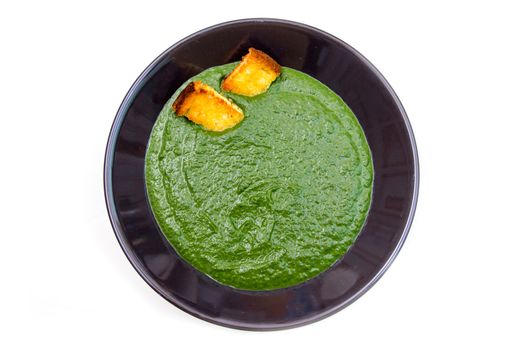 Creamed spinach and croutons on a white background top view