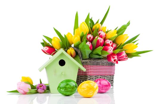 Easter eggs with tulips flowers and birdhouse, on a white background