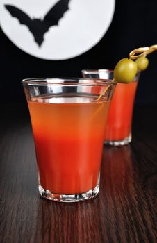 Bloody Mary cocktail with olives on a background of the moon