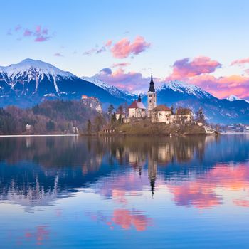 Sunset view of Julian Alps, Lake Bled with St. Marys Church of the Assumption on the small island. Bled, Slovenia, Europe.