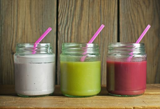 Smoothie beverages in jars including kiwi and strawberry