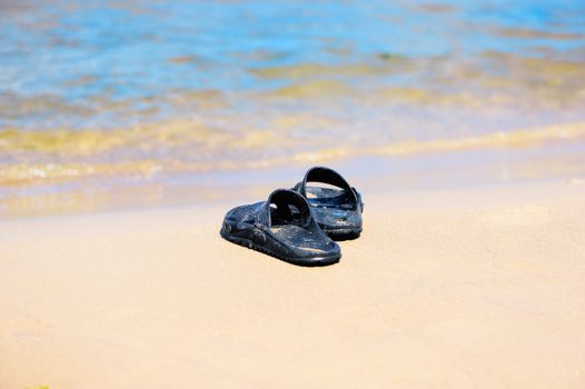 Rubber sandals on the sandy beach