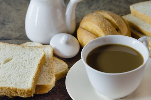 hot coffee with fresh bread on wooden  background  ,  still life