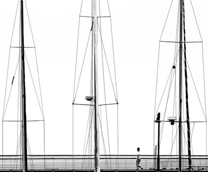 A man over a pier, trapped into sailboats