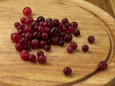 tasty and ripe cranberries on the wooden table