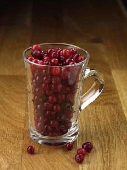 Cranberry glassy cup on the wooden table
