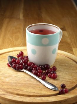 cranberry tea and berry on the wooden table