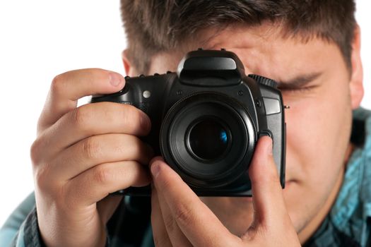 Male Photographer Shooting digital slr camera isolated on white.  Shallow depth of field.