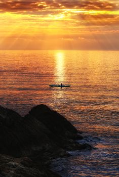 Man kayaking at sunset, Livorno (Tuscany)