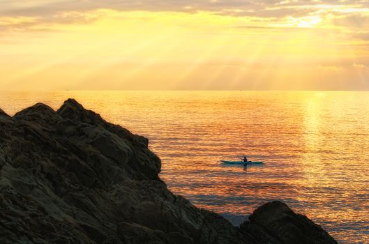 Man kayaking at sunset, Livorno (Tuscany)