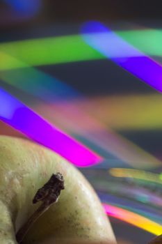 Red and green apples close-up photo with colorful background.