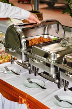 chafing dishes at table ready for wedding catering