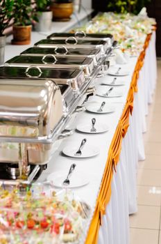 chafing dishes at table ready for wedding catering