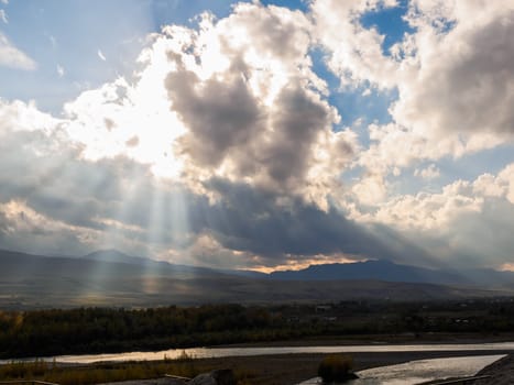 Sun rays from cloudy sky at Mtkvari River in Georgia