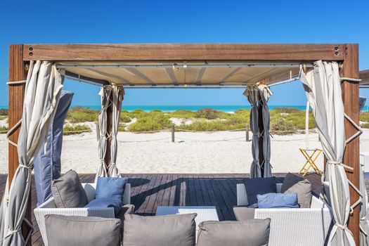 Armchairs on a beach with blue sky