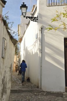 Sstreet of the Albaycin, a district of Granada, in Andalusia, Spain, that retains the narrow winding streets of its Medieval Moorish past. 
