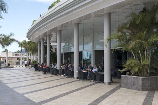 LOS CHRISTIANOS,TENERIFE-NOVEMBER 28, 2014: People enjoy vacation sitting on the terrace of the luxury  hotel in Tenerife, on November 28,Tenerife tis one of the popular island of canadian islands.