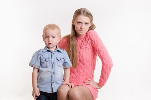 Young beautiful mother scolds her rebellious and moody three year old boy