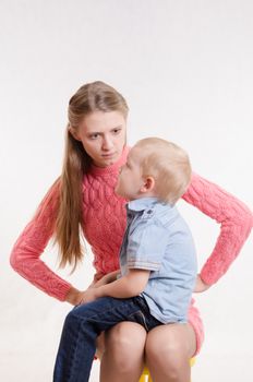 Young beautiful mother scolds her rebellious and moody three year old boy
