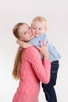Young beautiful girl hugging his three sons