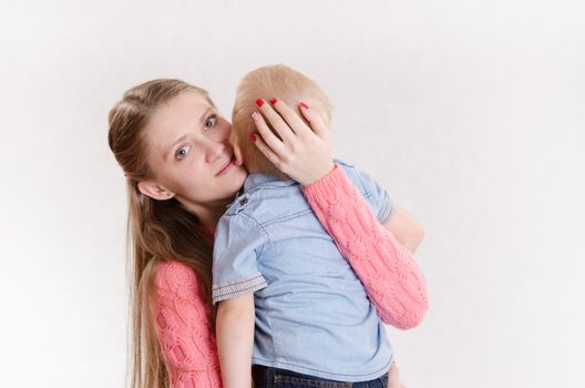 Young beautiful girl hugging his three sons
