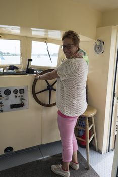 woman at the helm of the boat