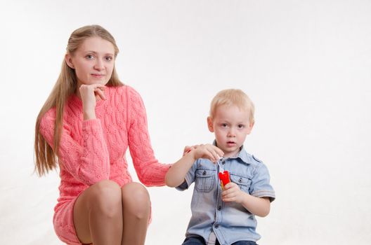 Young beautiful girl blow bubbles with a three year old son