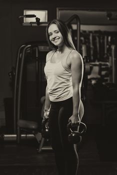 Young Woman Working Out With Kettle Bell