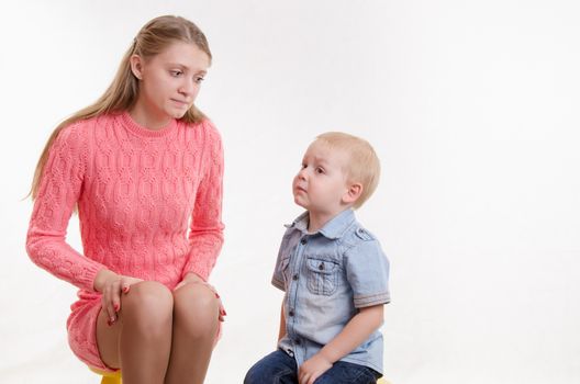 Young beautiful mother scolds her rebellious and moody three year old boy
