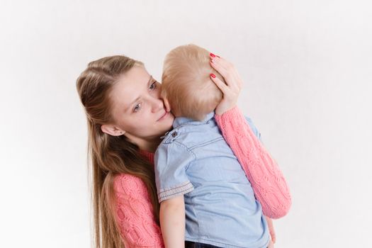 Young beautiful girl hugging his three sons