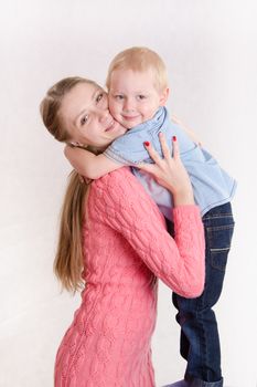 Young beautiful girl hugging his three sons