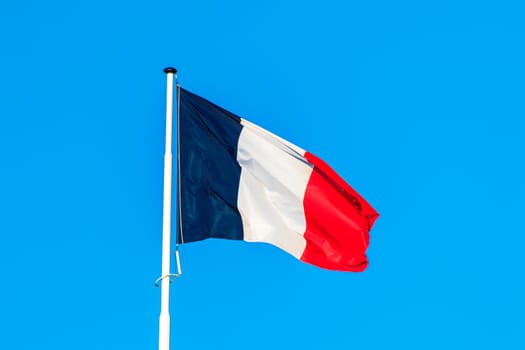 the french flag with blue sky in the background