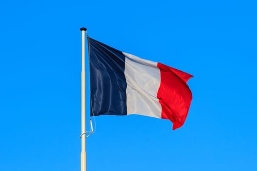 the french flag with blue sky in the background