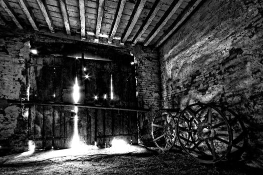 A very old doorway with 2 old wheels tractor