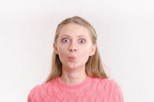 Portrait of a young emotional beautiful girl of the European appearance on a white background