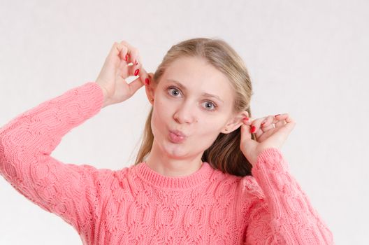 Portrait of a young emotional beautiful girl of the European appearance on a white background