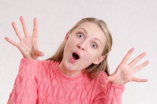 Portrait of a young emotional beautiful girl of the European appearance on a white background