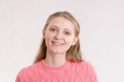 Portrait of a young emotional beautiful girl of the European appearance on a white background