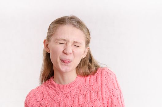 Portrait of a young emotional beautiful girl of the European appearance on a white background