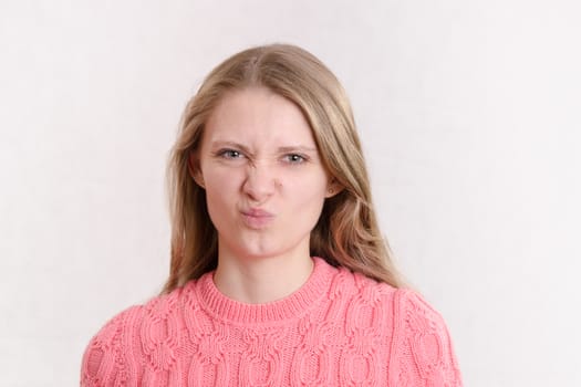 Portrait of a young emotional beautiful girl of the European appearance on a white background