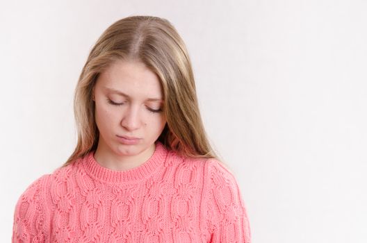 Portrait of a young emotional beautiful girl of the European appearance on a white background