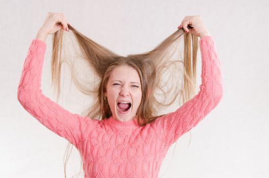 Portrait of a young emotional beautiful girl of the European appearance on a white background