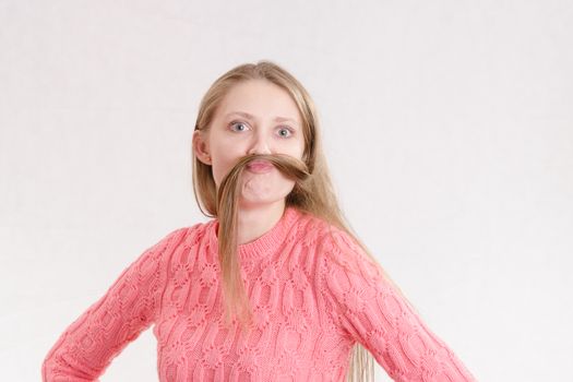 Portrait of a young emotional beautiful girl of the European appearance on a white background