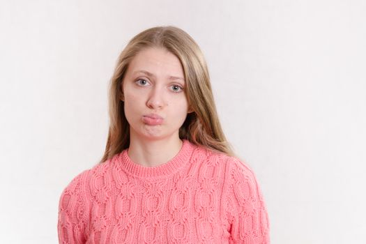 Portrait of a young emotional beautiful girl of the European appearance on a white background